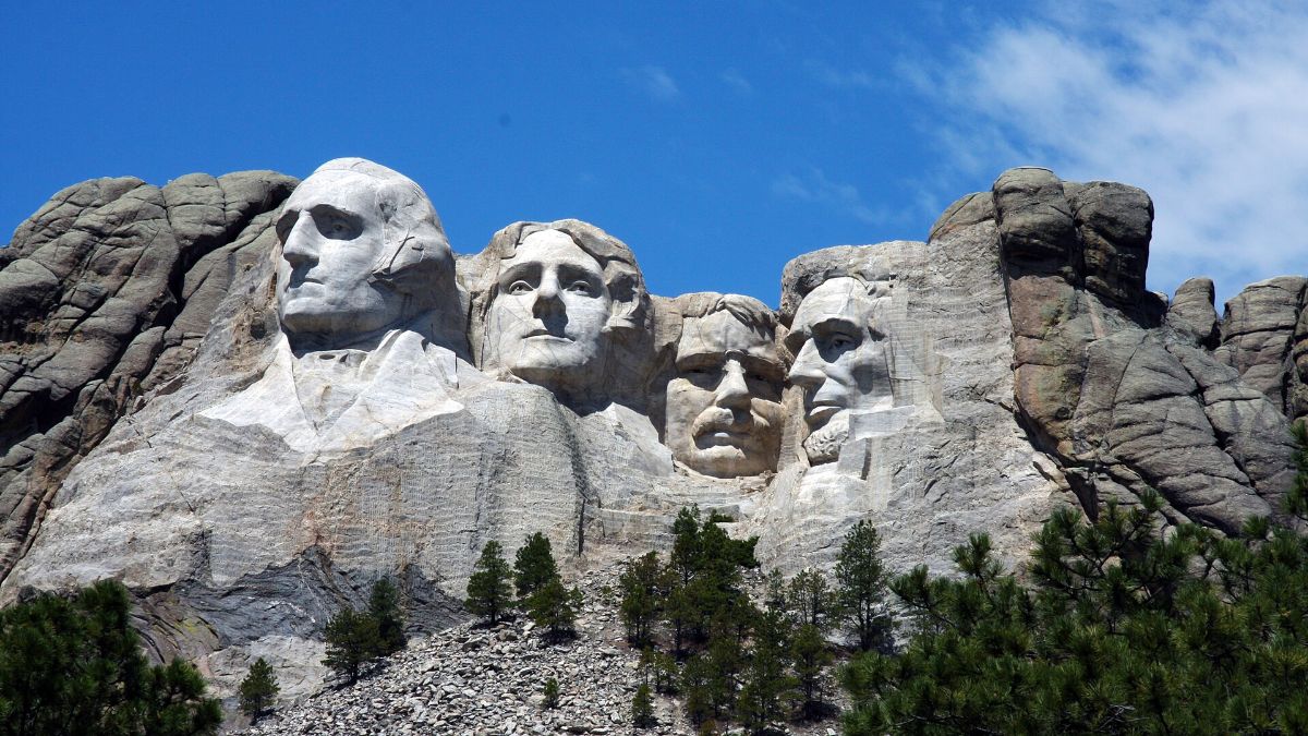 The faces of Mount Rushmore National Memorial against a blue sky